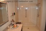 A Bathroom with Staron Countertop Shower with Bench Seat Custom Dark Oak Cabinetry Vinyl Flooring (16) sm