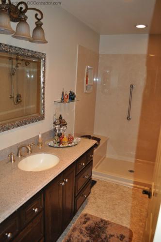 A Bathroom with Staron Countertop Shower with Bench Seat Custom Dark Oak Cabinetry Vinyl Flooring (17) lg