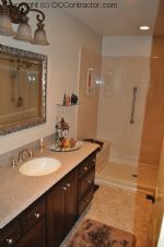 A Bathroom with Staron Countertop Shower with Bench Seat Custom Dark Oak Cabinetry Vinyl Flooring (17) sm