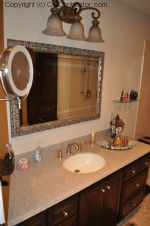 A Bathroom with Staron Countertop Shower with Bench Seat Custom Dark Oak Cabinetry Vinyl Flooring (18) sm